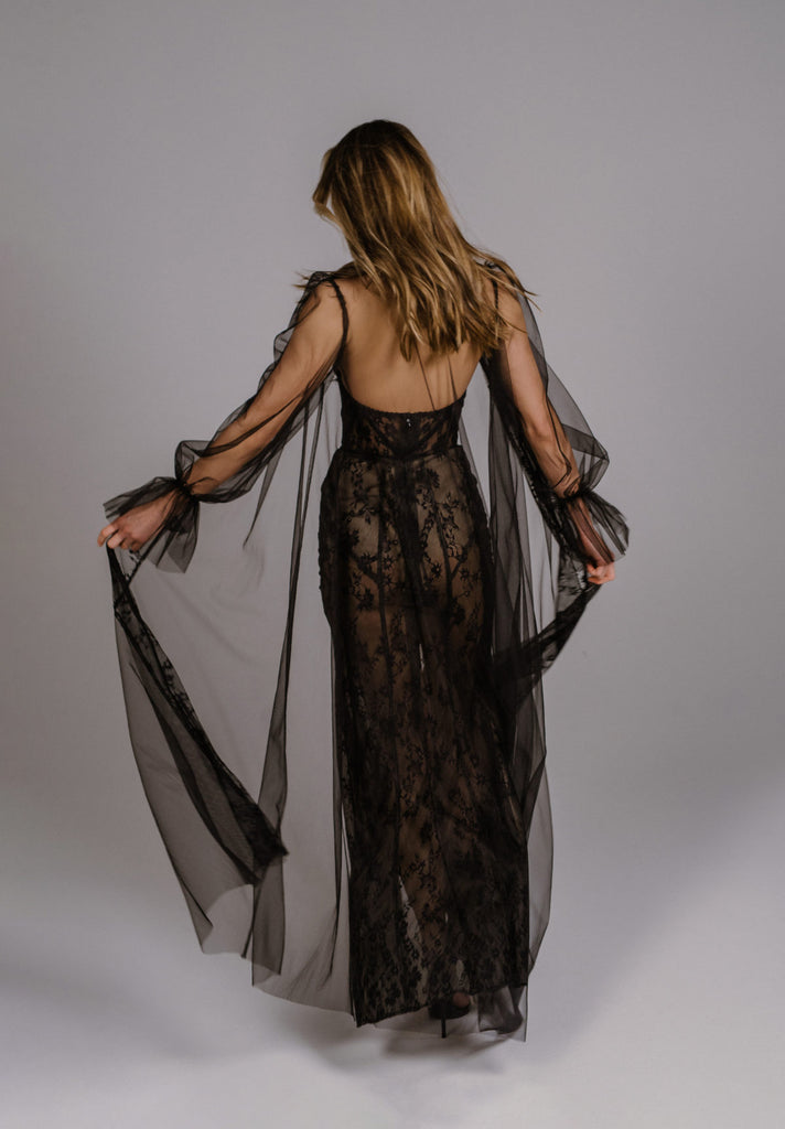 RAZIL is a dramatic and audacious evening gown. This corset dress is handcrafted in luscious black lace, boasting a modern geometric pattern. The classic dreamy silhouette is achieved thanks to the addition of a beautiful tulle robe. This bold gown dynamic and sexy, with playful sheer layers masterfully applied with elite craftsmanship.