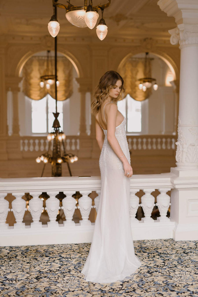 FLORENTINE is a sexy, figure-flattering Wedding Dress that is truly one of a kind. It’s crafted in gentle blush tulle and ravishes with luscious hand-embroidered lace, embellished with just the right amount of stones. This dress is paired with a stunning tulle robe, adorned with shimmering stones, giving the final look a hint of intrigue. 